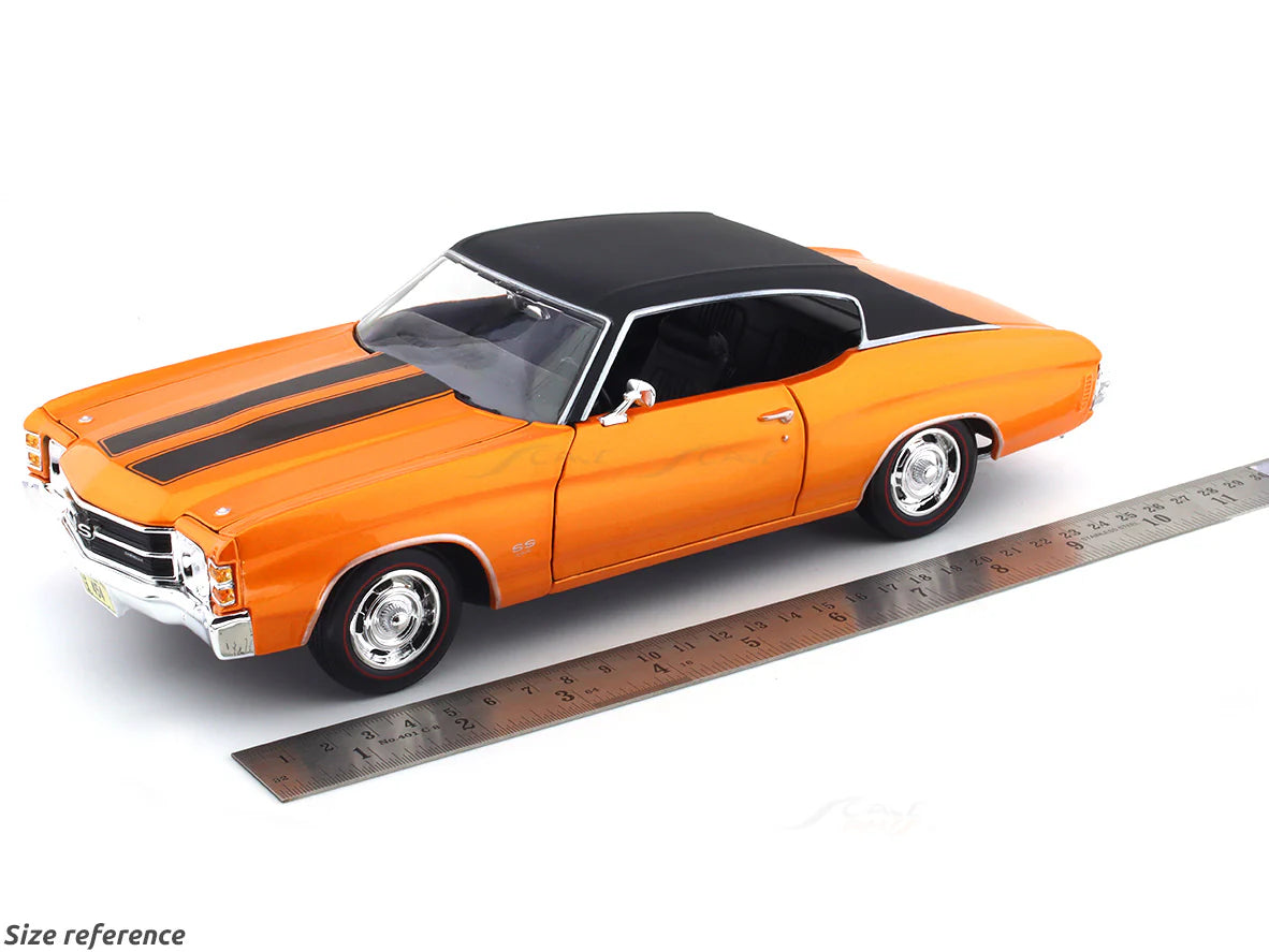 Orange model car with black roof next to a ruler for size reference on a white background