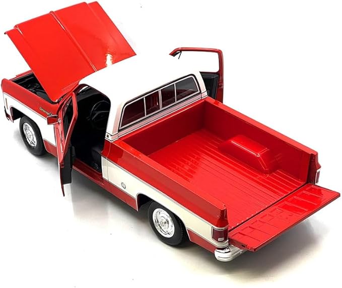 Model truck with open doors and bed on a white background