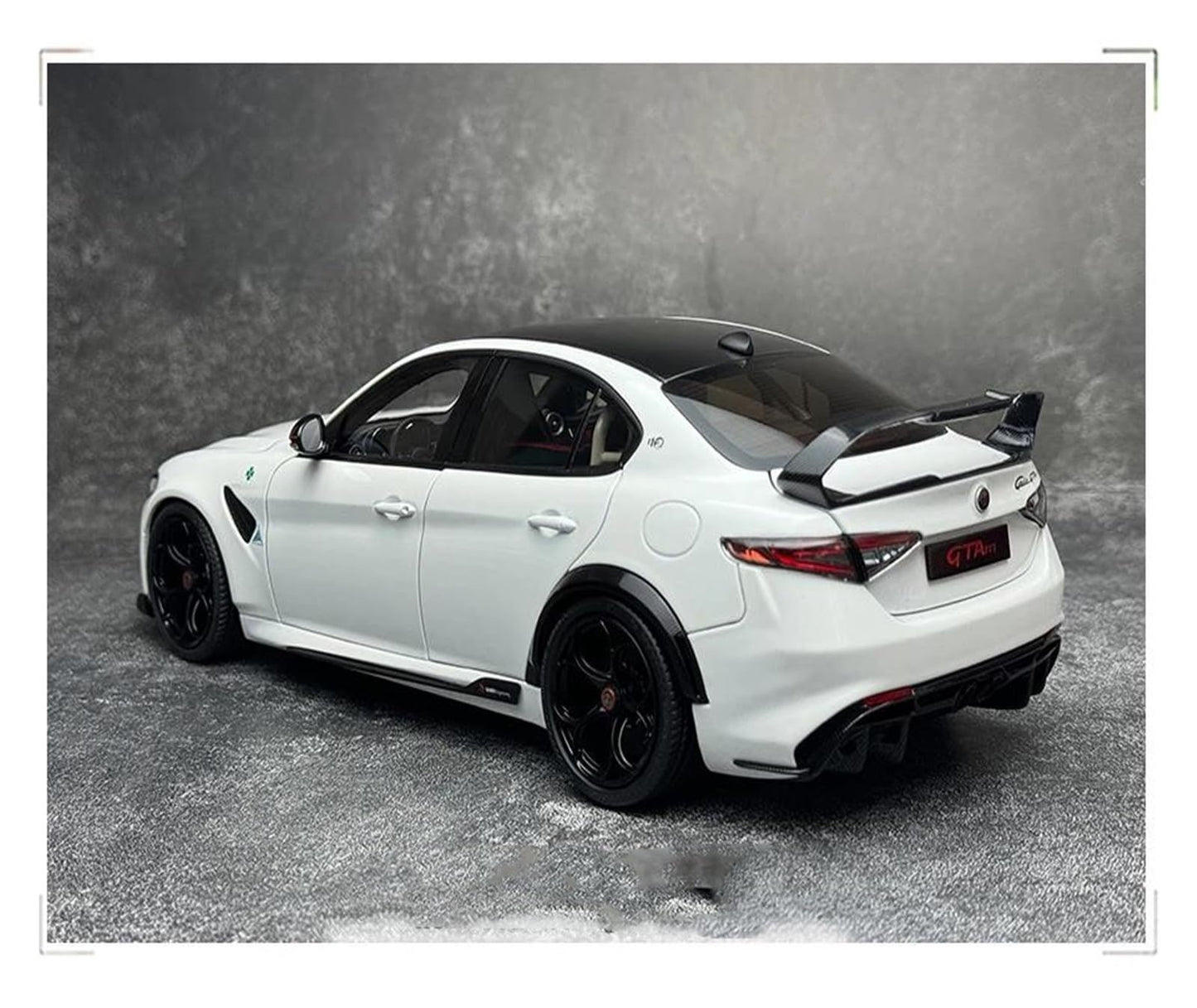 White sports car with black accents on a gray background