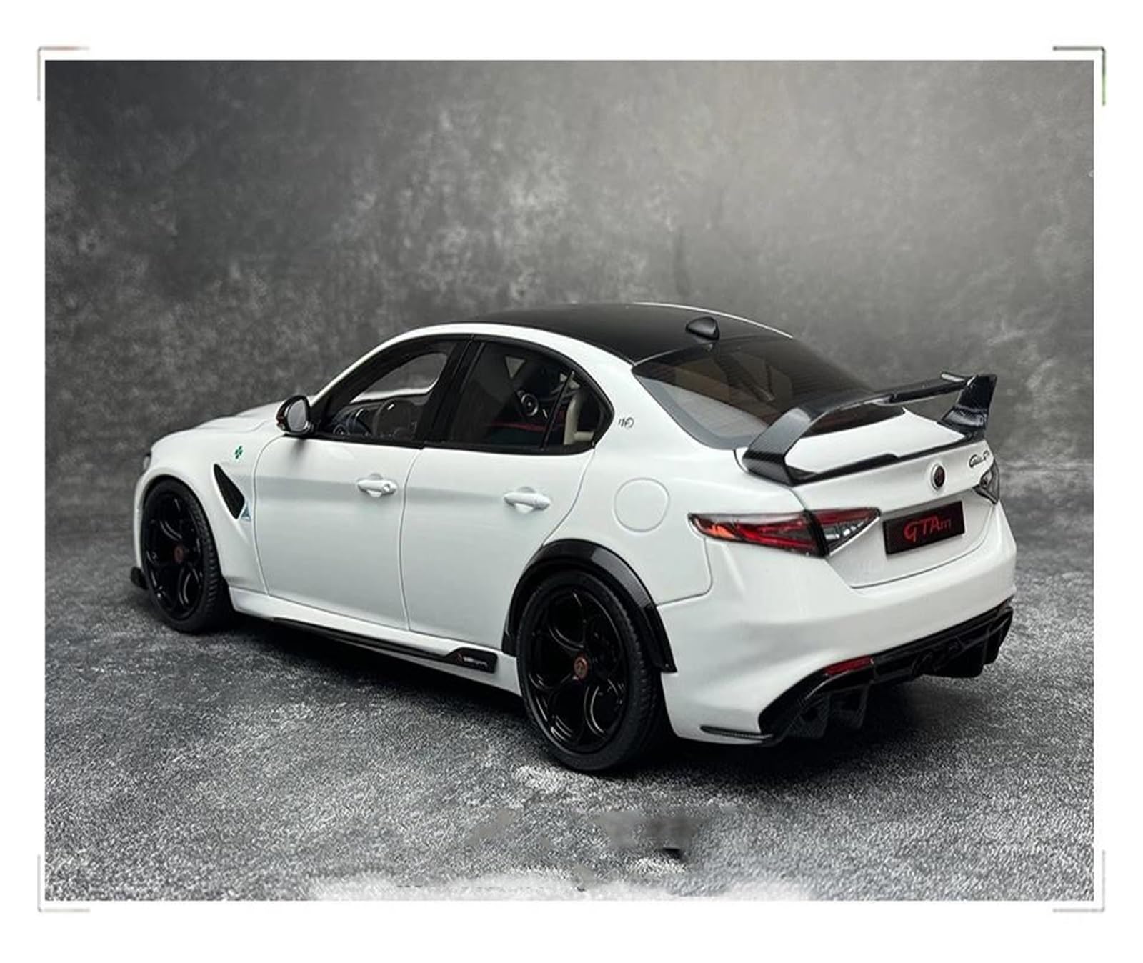 White sports car with black accents on a gray background